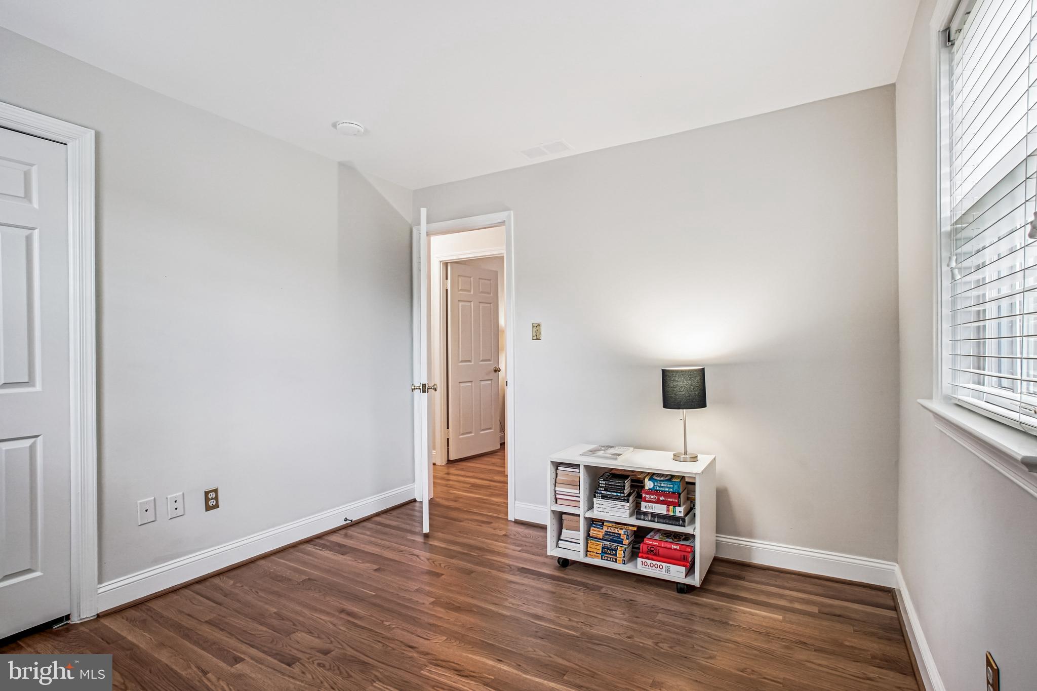 6719 Fairfax Road, Unit 67 Chevy Chase, MD 20815 - Photo 17 of 24 an empty room with window and couch