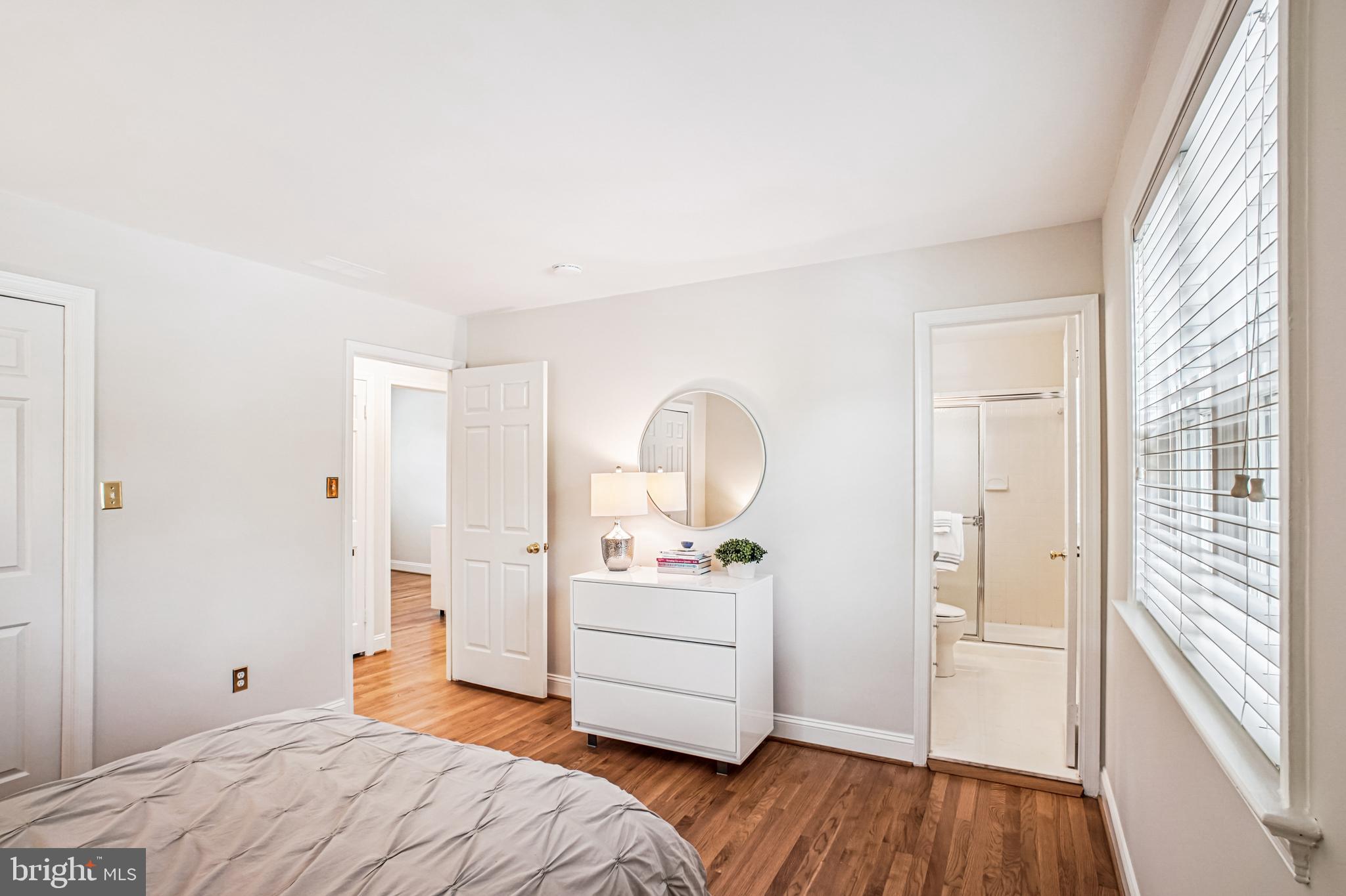 6719 Fairfax Road, Unit 67 Chevy Chase, MD 20815 - Photo 20 of 24 a bedroom with a bed and a wooden floor