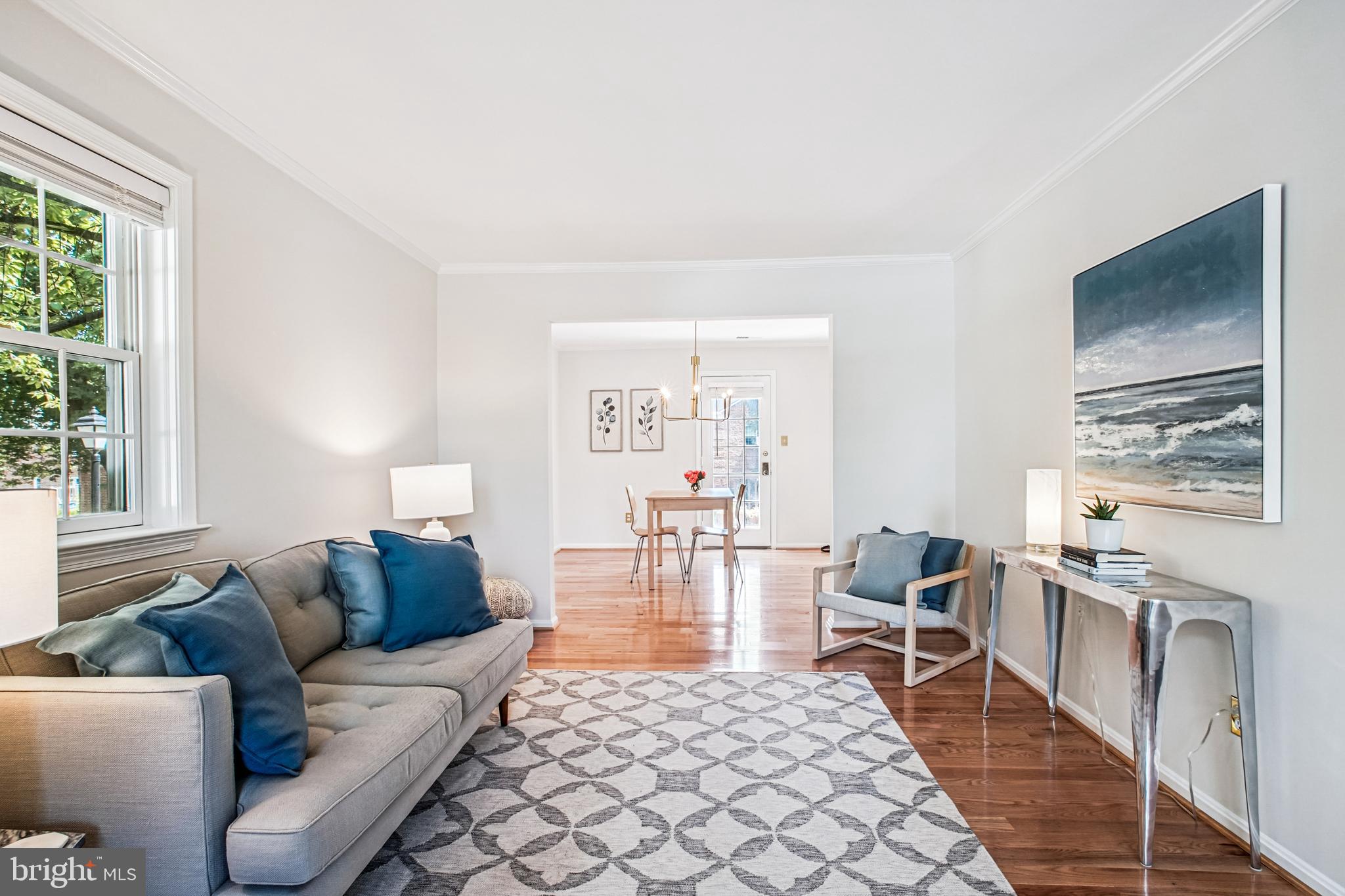 6719 Fairfax Road, Unit 67 Chevy Chase, MD 20815 - Photo 6 of 24 a living room with furniture a flat screen tv and a table