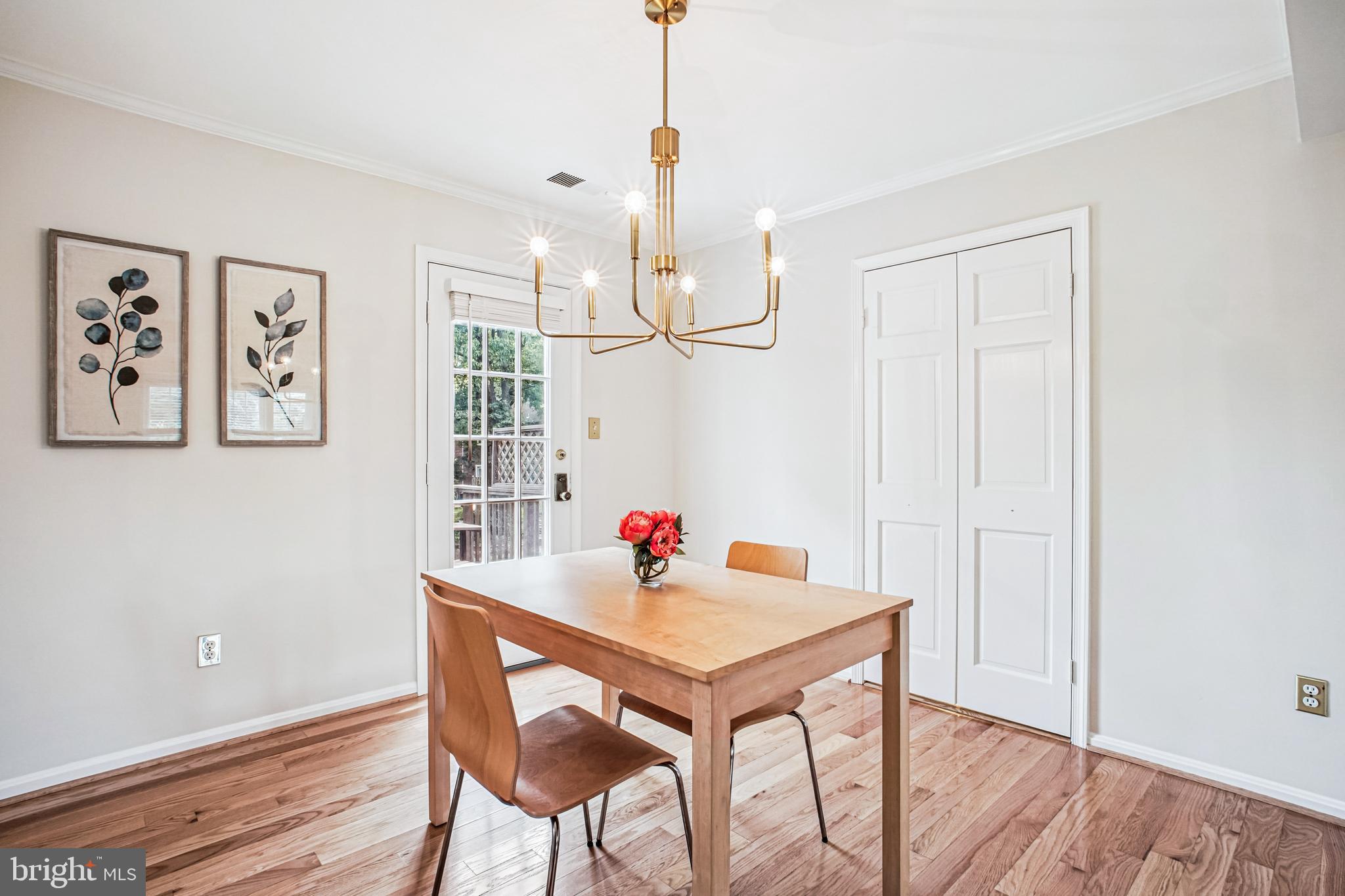 6719 Fairfax Road, Unit 67 Chevy Chase, MD 20815 - Photo 8 of 24 a view of a dining room with furniture wooden floor and chandelier