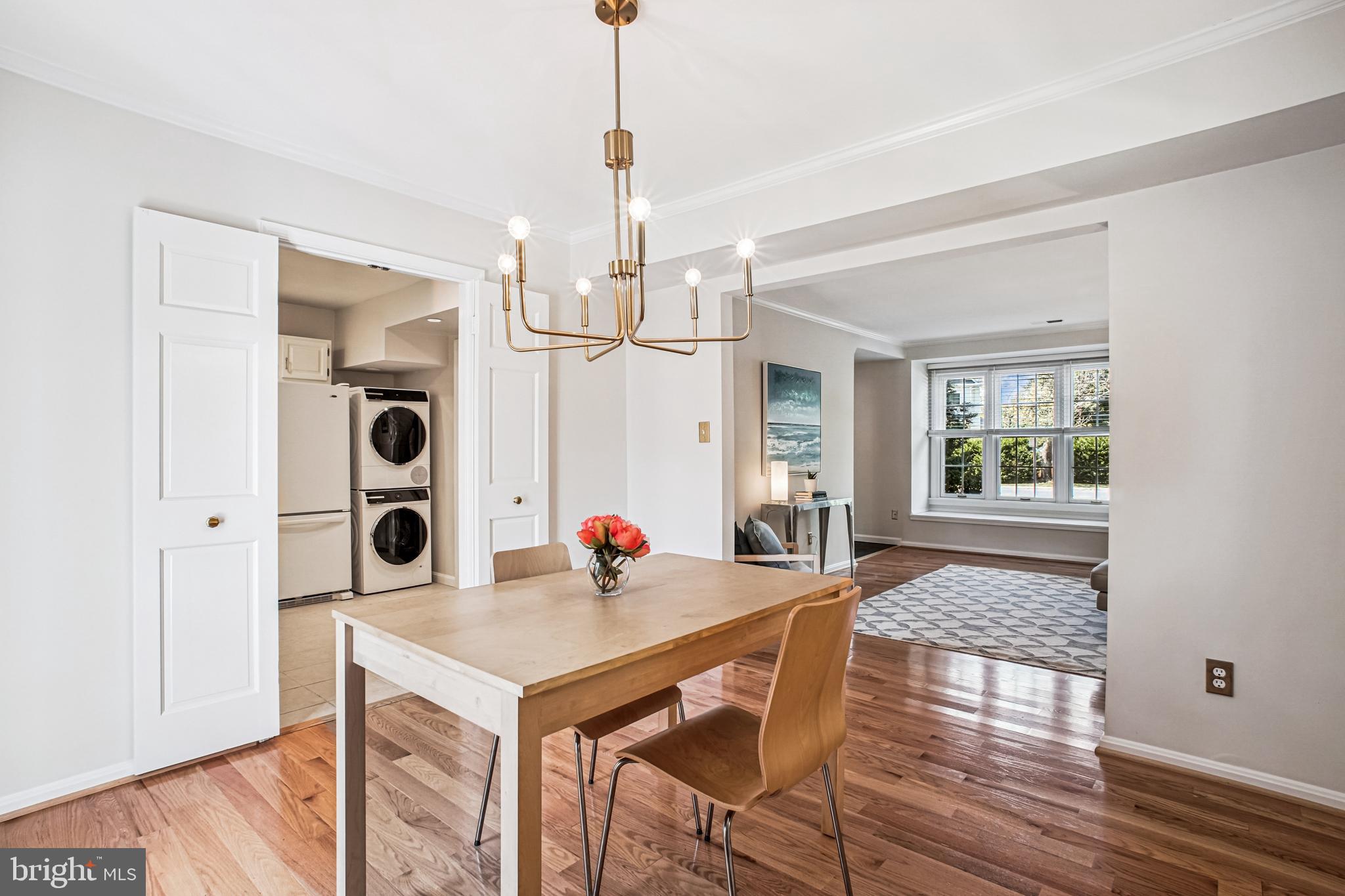 6719 Fairfax Road, Unit 67 Chevy Chase, MD 20815 - Photo 9 of 24 a view of a dining room and livingroom with furniture wooden floor a chandelier