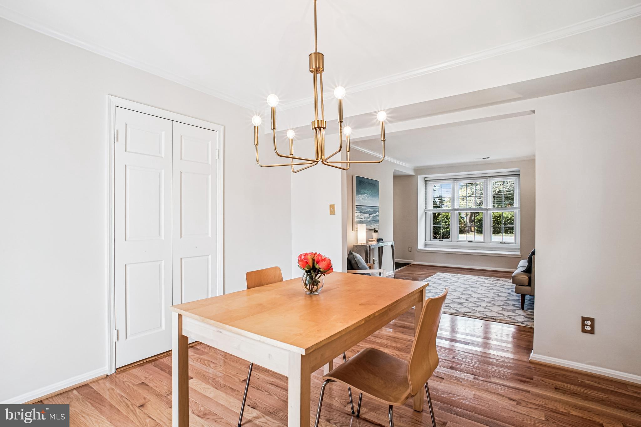6719 Fairfax Road, Unit 67 Chevy Chase, MD 20815 - Photo 10 of 24 a dining room with table chairs and wooden floor