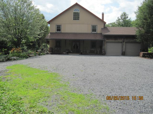 953 Clearfield Road Nazareth, PA 18064 - Photo 1 of 25 a front view of a house with a yard and garage
