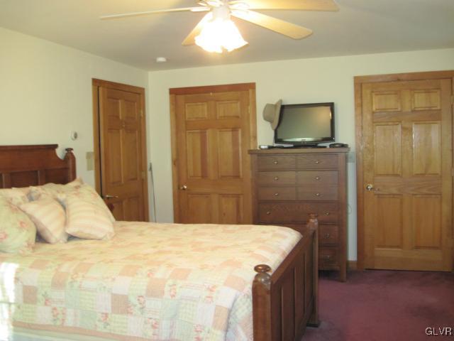 953 Clearfield Road Nazareth, PA 18064 - Photo 15 of 25 a bedroom with a bed and a flat tv screen on dresser