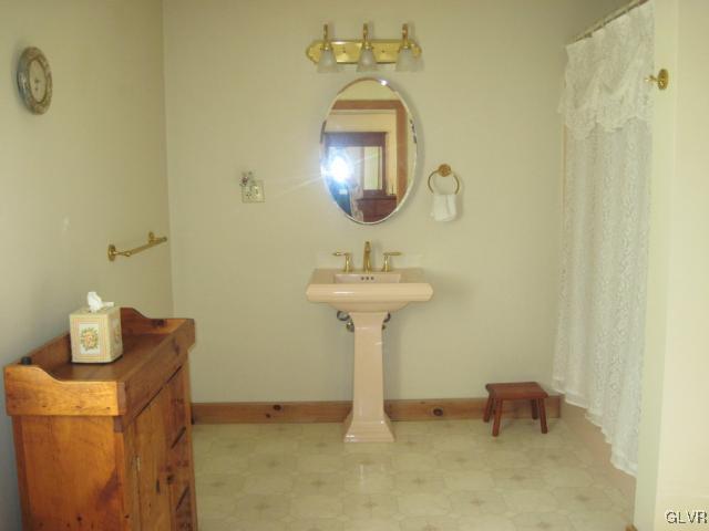 953 Clearfield Road Nazareth, PA 18064 - Photo 16 of 25 a bathroom with a sink a mirror and a light fixture
