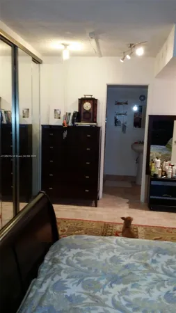 a living room with stainless steel appliances kitchen island granite countertop a refrigerator stove and sink