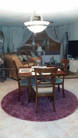 a view of a couches and table in kitchen