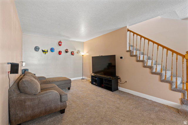 165 Pheasantbrook Drive Centerville, UT 84014 - Photo 11 of 30 Living room featuring a textured ceiling and light colored carpet