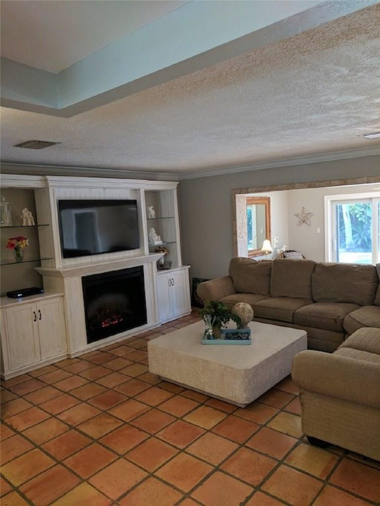 1400 Southwest 9th Street Boca Raton, FL 33486 - Photo 3 of 8 a living room with furniture a fireplace and a flat screen tv