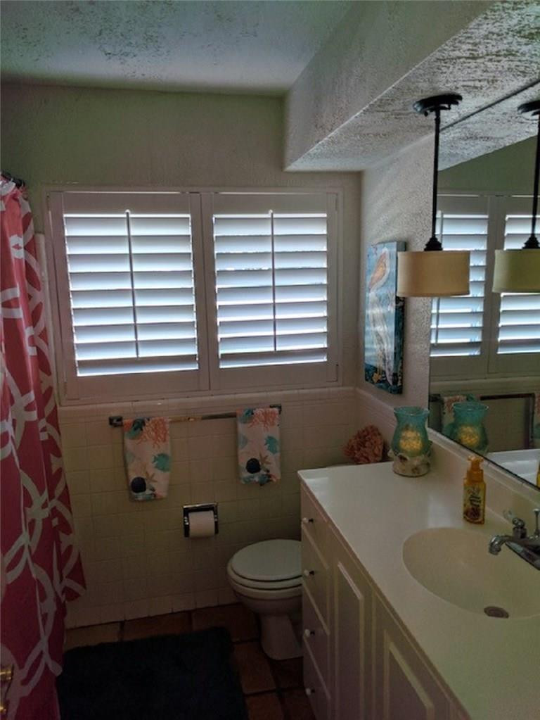 1400 Southwest 9th Street Boca Raton, FL 33486 - Photo 7 of 8 a bathroom with a sink a toilet and a mirror