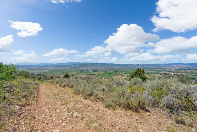 2459 Painter Road Marion, UT 84036 - Photo 14 of 42 Expansive mountain landscape featuring a distant valley, rolling hills, and a clear sky with scattered clouds