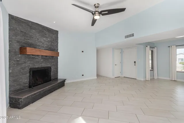 a view of an empty room with a fireplace