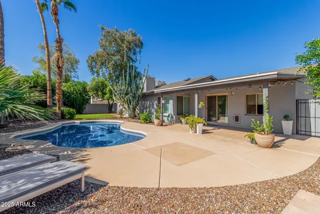 a view of a backyard with plants and patio