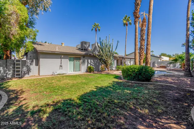 a view of a house with a backyard
