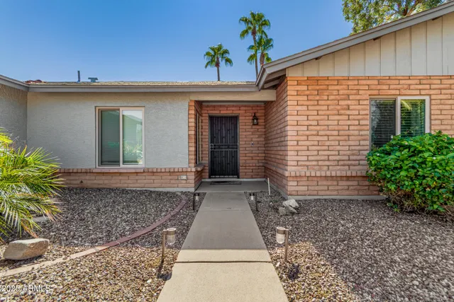 a view of a house with potted plants