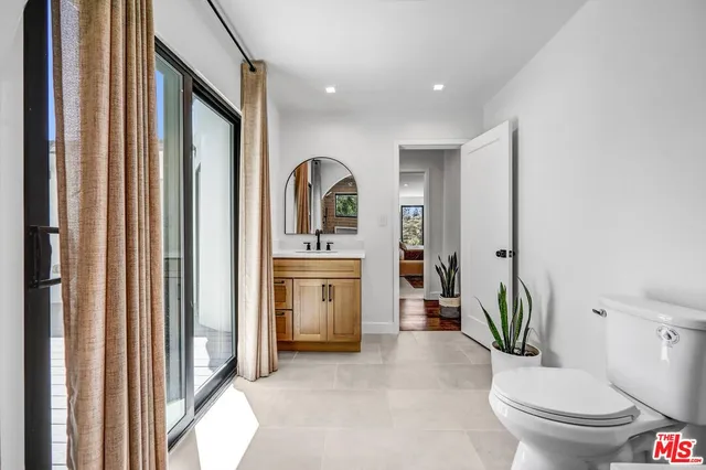 a bedroom with a bed and a potted plant