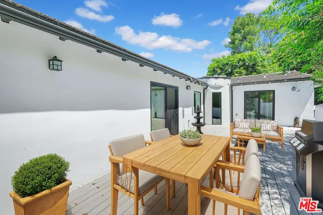 a patio with a yard table and chairs