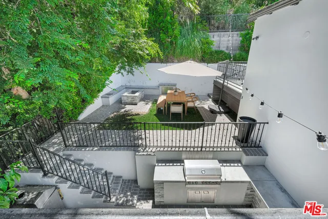 an aerial view of a house with a yard and potted plants