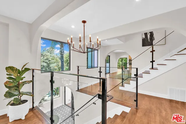a view of a balcony with furniture and a chandelier