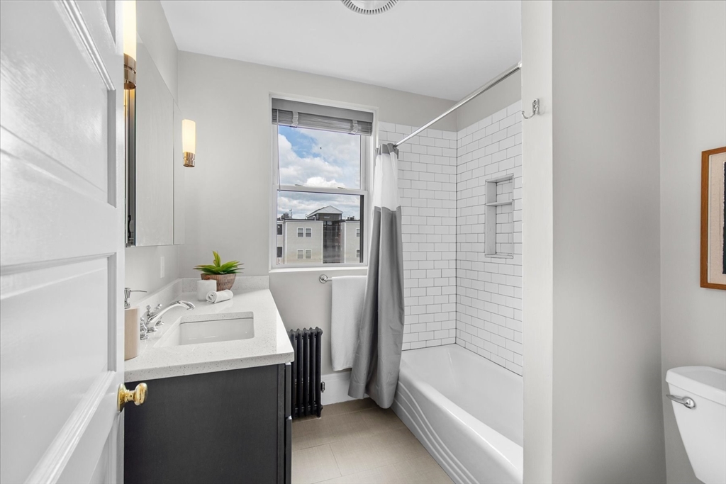 9 Verndale Street, Unit 2 Brookline, MA 02446 - Photo 26 of 39 a bathroom with a sink a toilet and shower