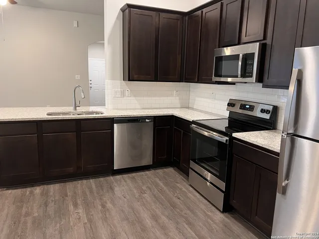 a kitchen with a sink stove and microwave