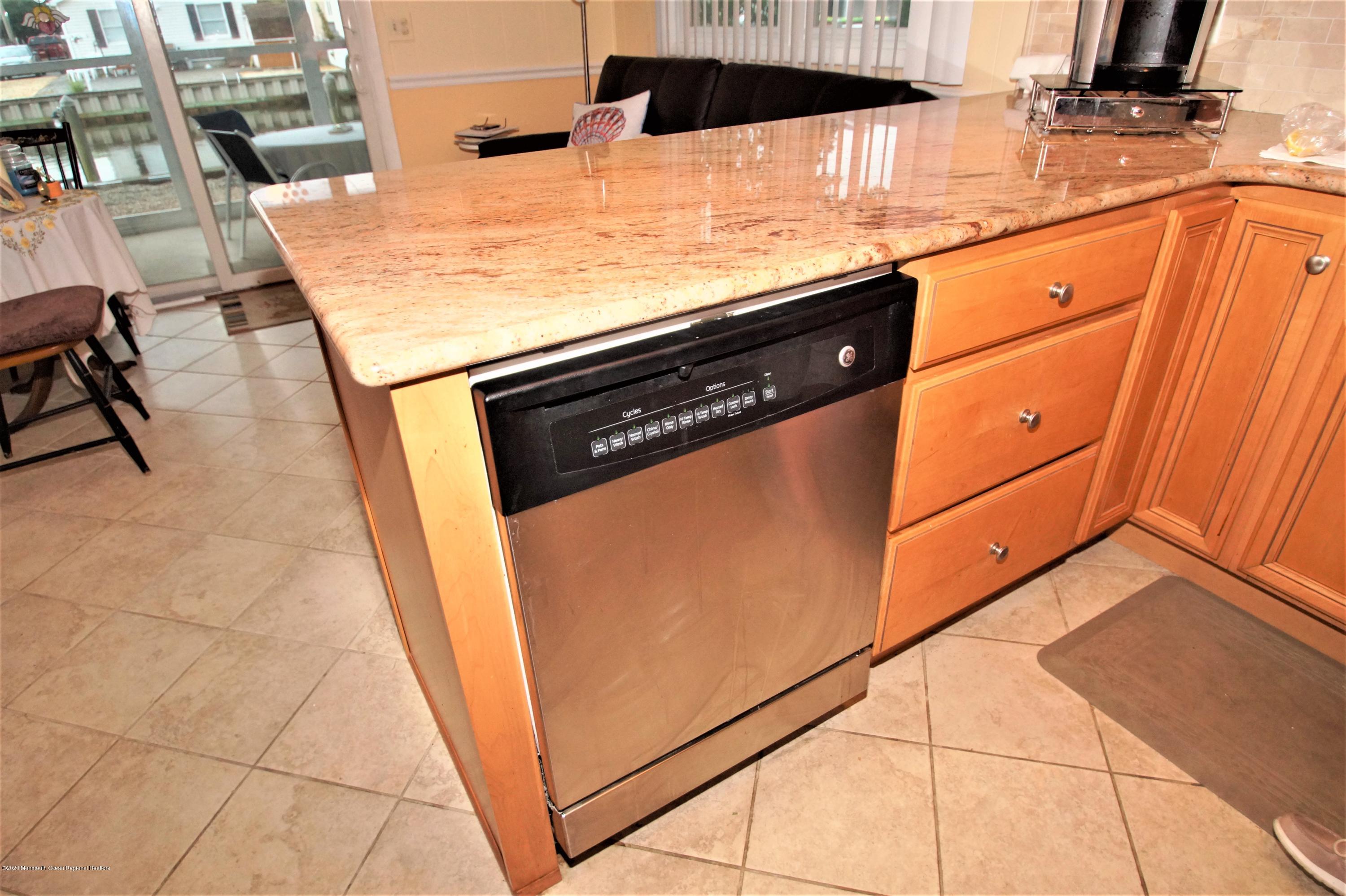 63 Mizzen Road Brick, NJ 08723 - Photo 11 of 37 a kitchen with stainless steel appliances cabinets and wooden floor