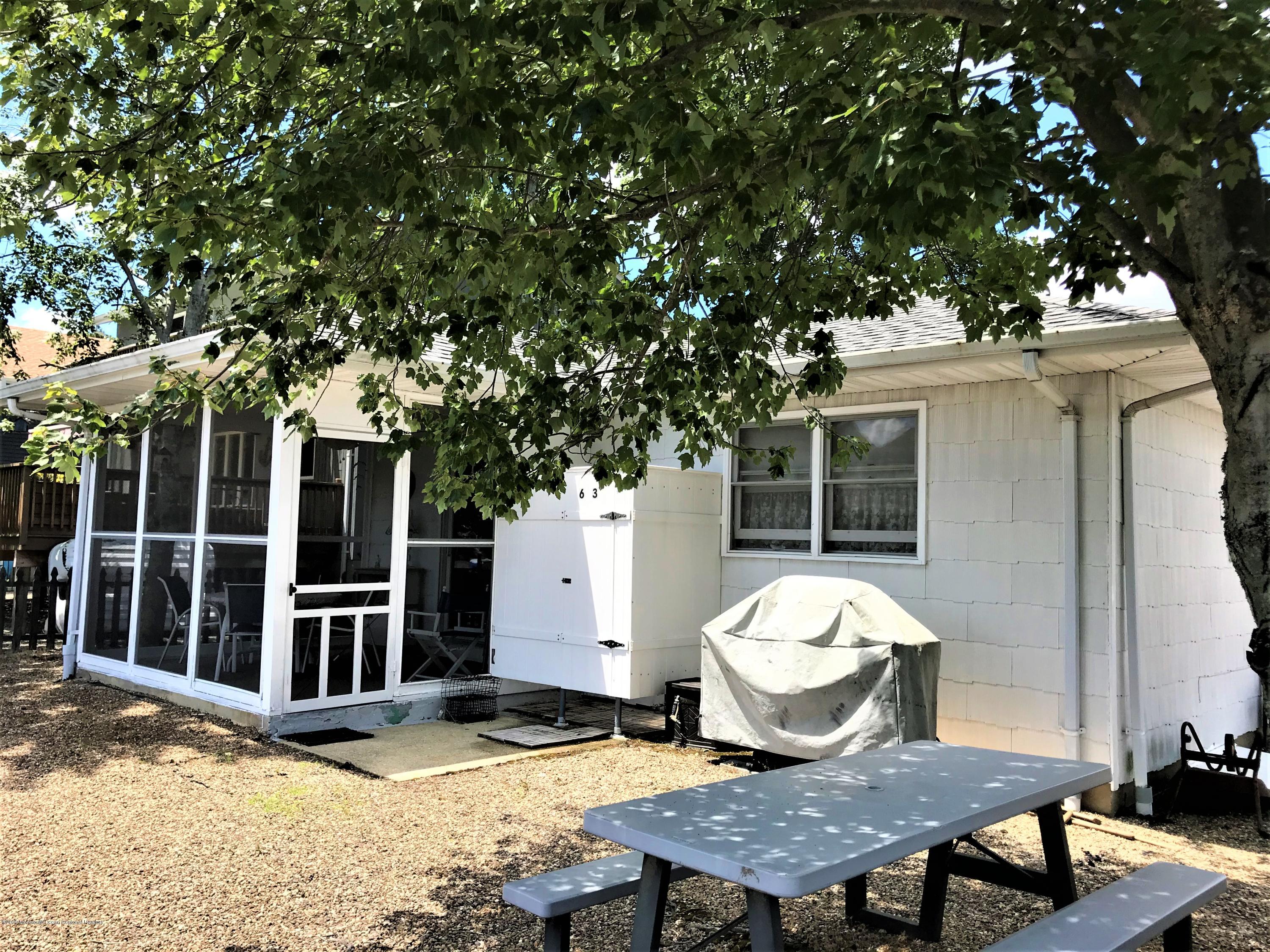 63 Mizzen Road Brick, NJ 08723 - Photo 19 of 37 a view of a dinning table and chairs in patio