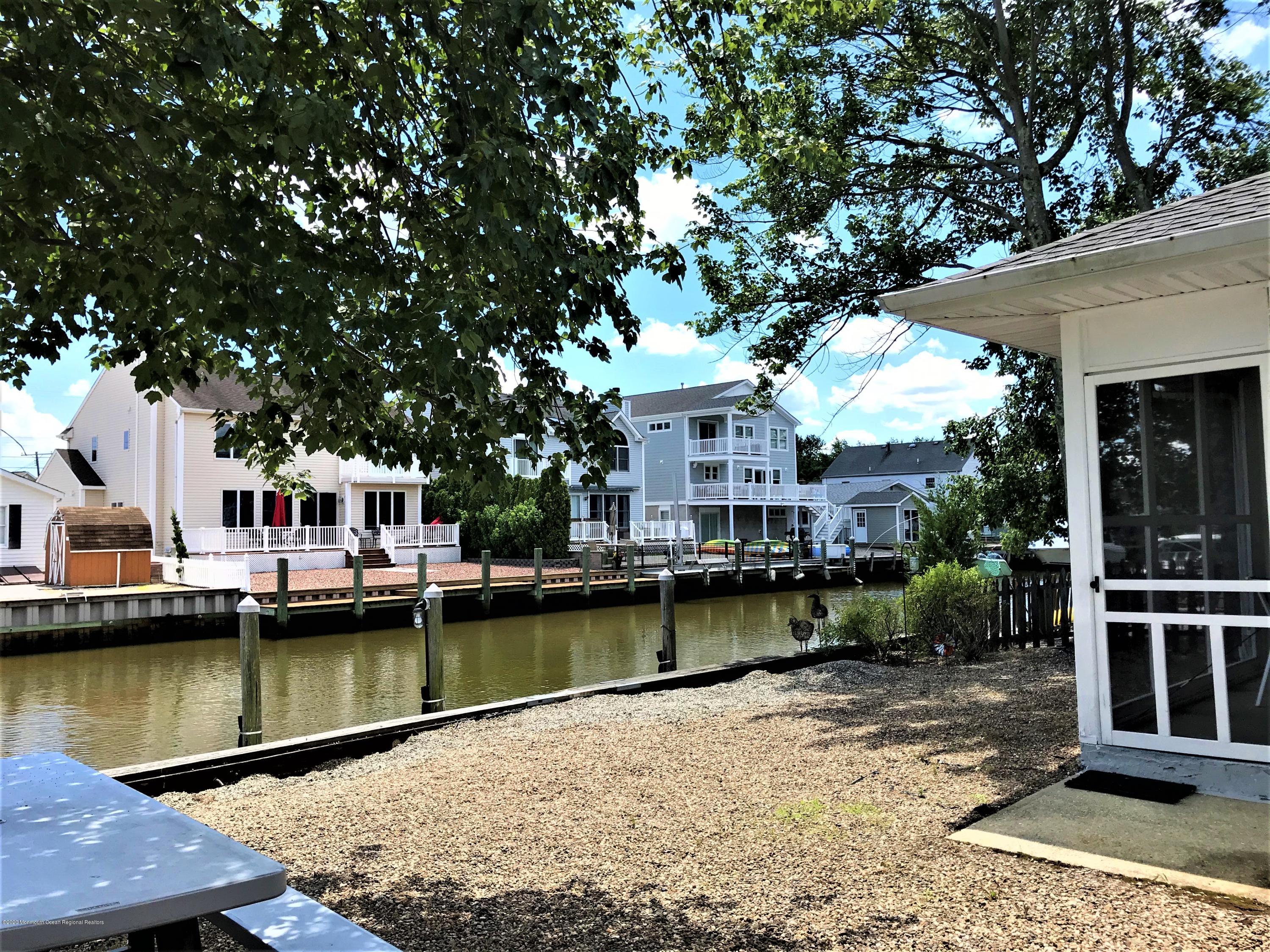 63 Mizzen Road Brick, NJ 08723 - Photo 20 of 37 a view of a lake with a house and outdoor space