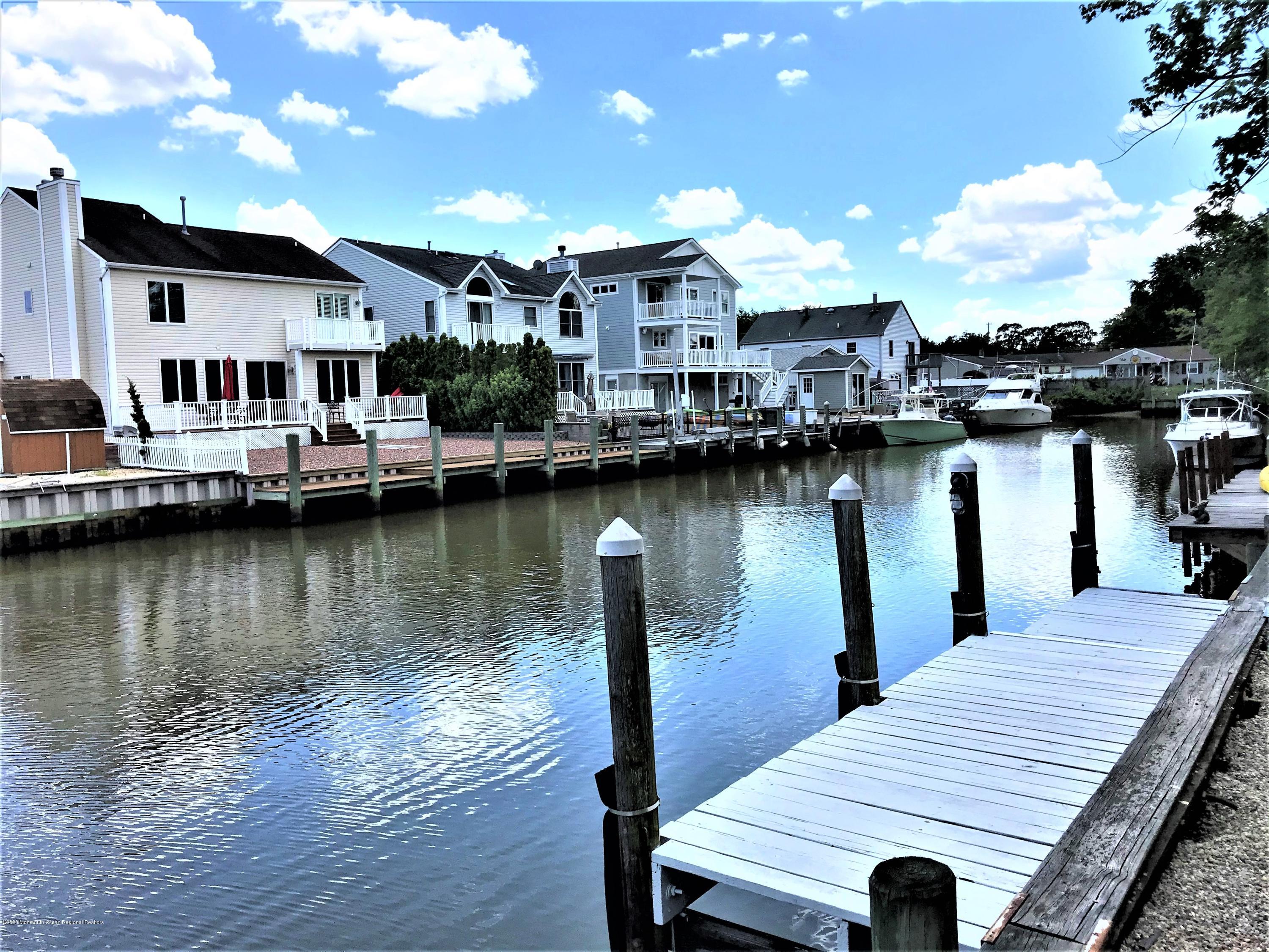 63 Mizzen Road Brick, NJ 08723 - Photo 21 of 37 a view of a lake with houses