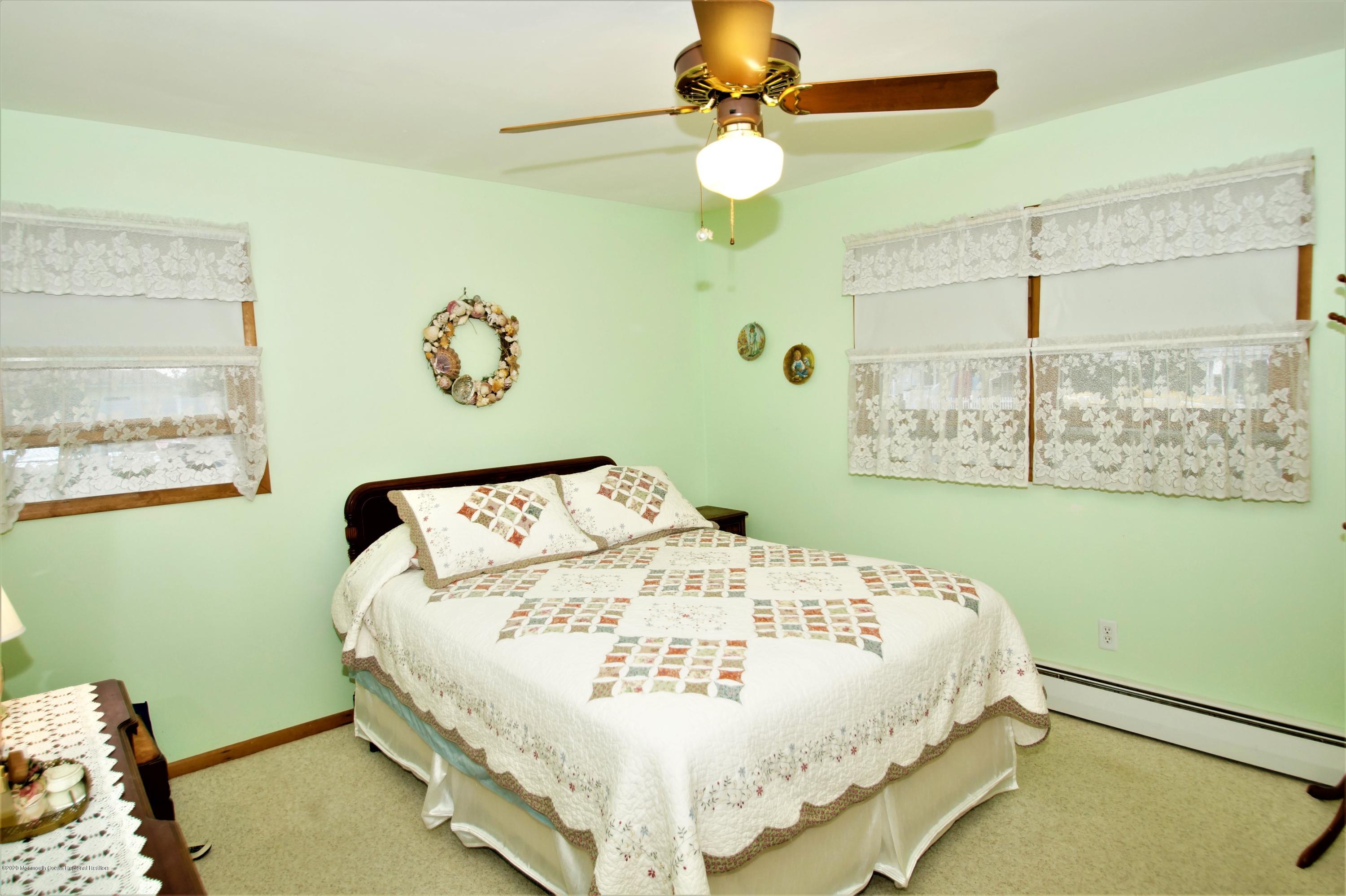 63 Mizzen Road Brick, NJ 08723 - Photo 24 of 37 a bed sitting in a bedroom next to a window