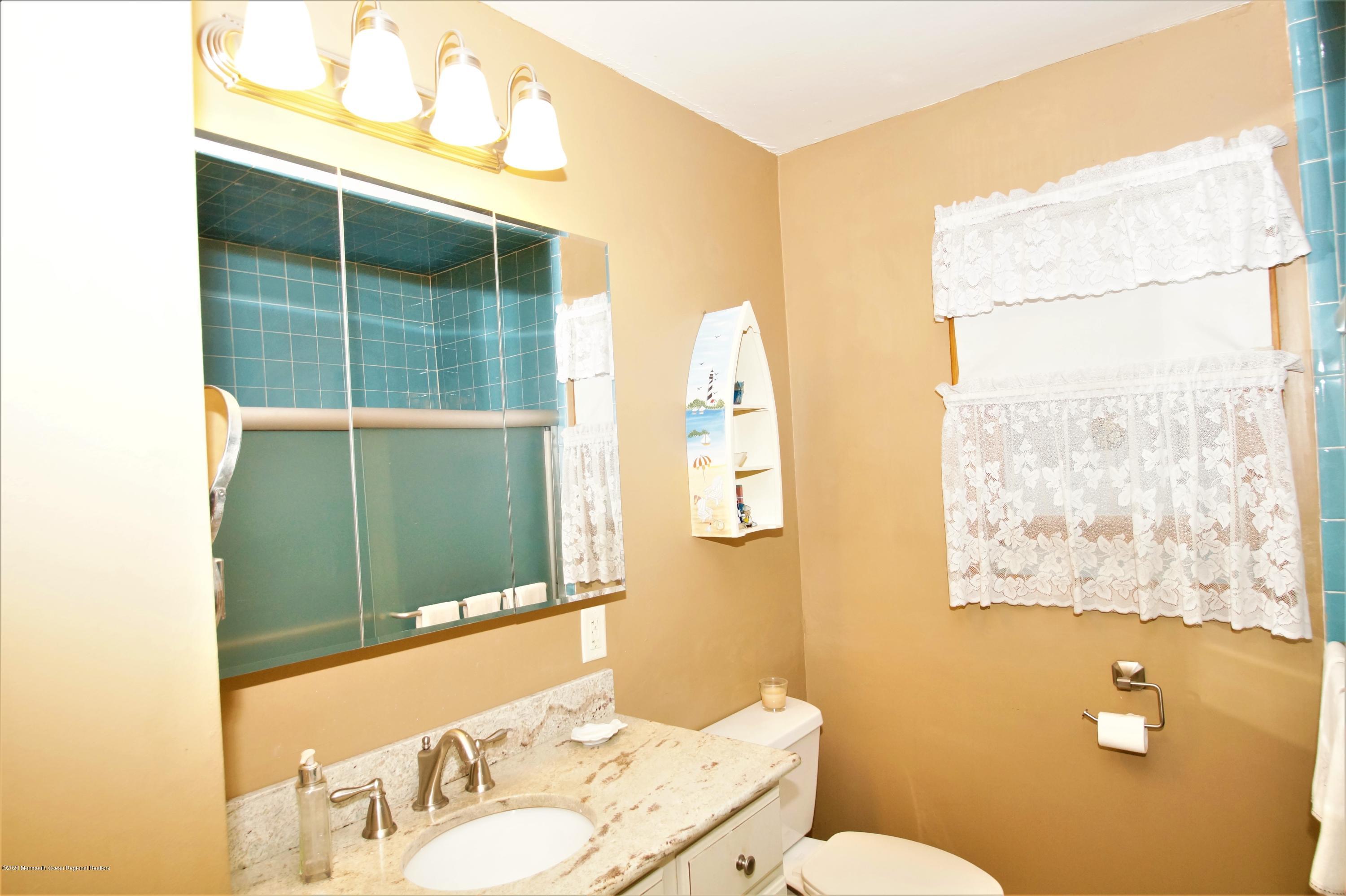 63 Mizzen Road Brick, NJ 08723 - Photo 25 of 37 a bathroom with a sink mirror vanity and toilet