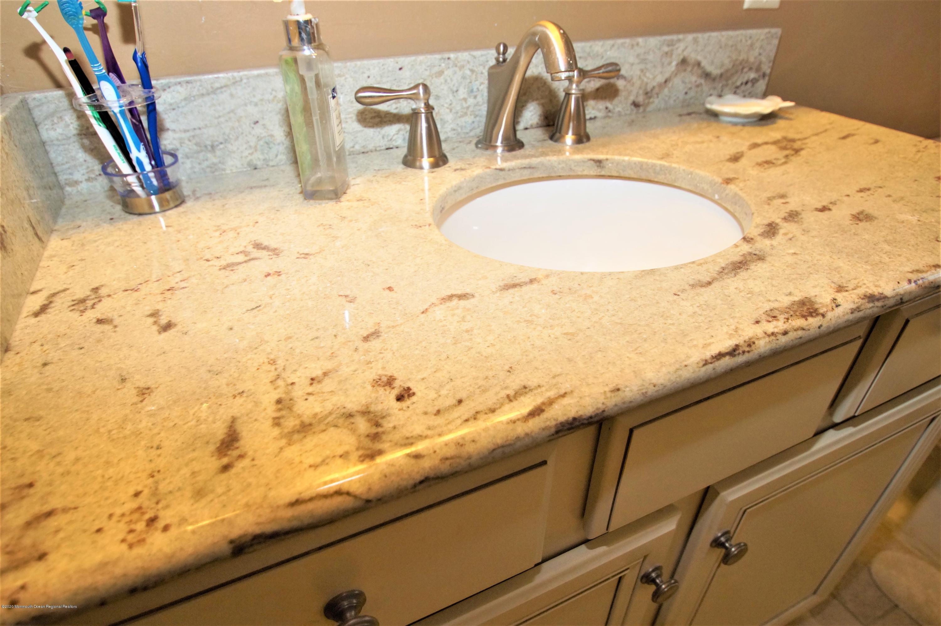 63 Mizzen Road Brick, NJ 08723 - Photo 26 of 37 a bathroom with a sink and a mirror