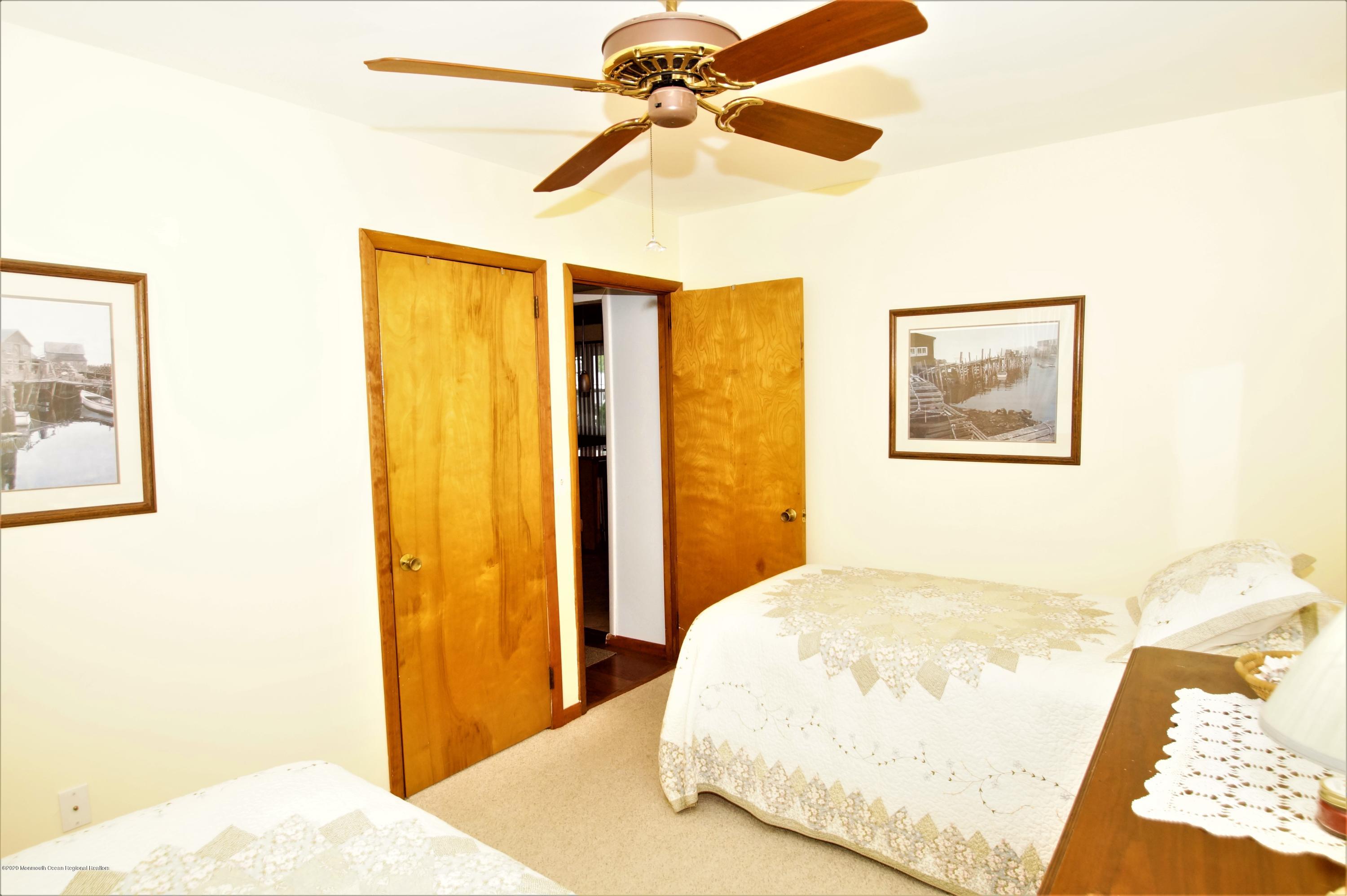 63 Mizzen Road Brick, NJ 08723 - Photo 29 of 37 a bedroom with a bed and a chandelier