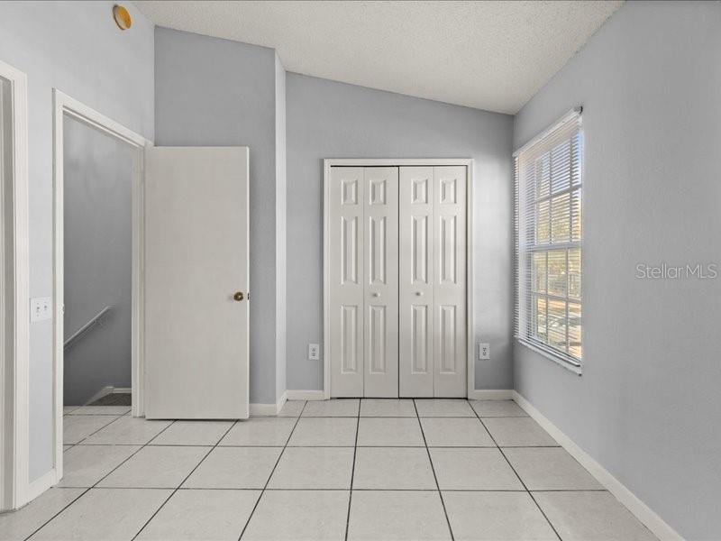 29924 Playa Del Rey Lane Wesley Chapel, FL 33543 - Photo 13 of 31 a view of an empty room with window and closet area