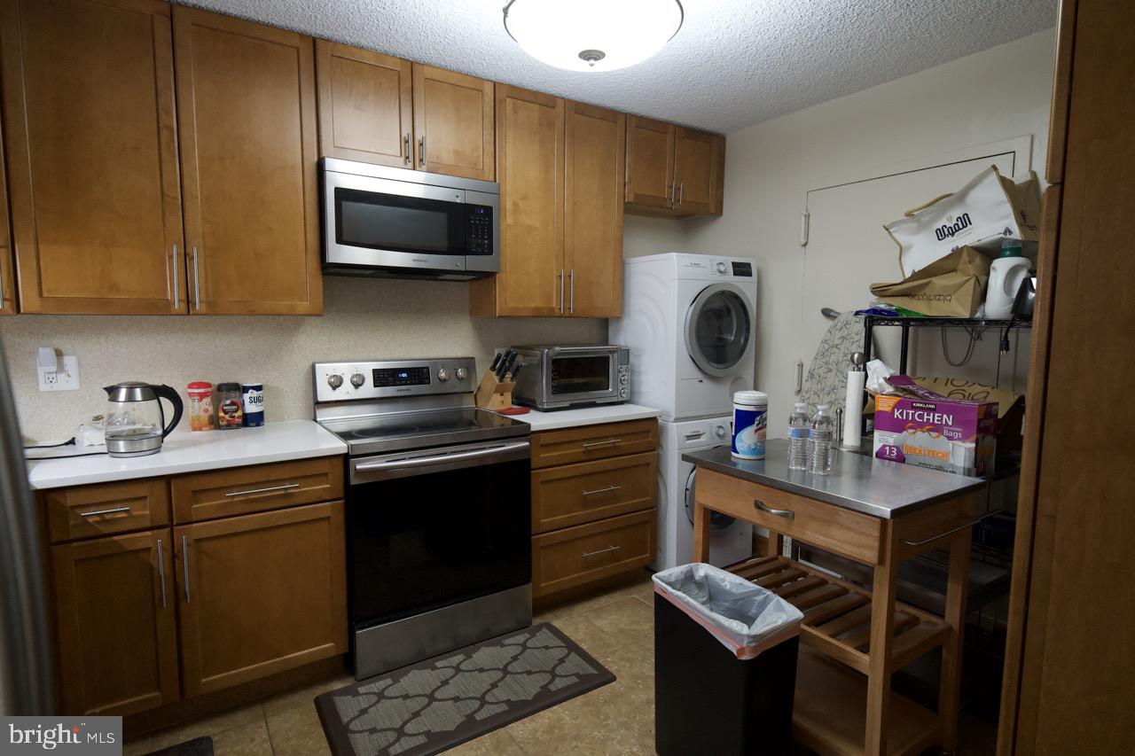 1800 Old Meadow Road, Unit 818 McLean, VA 22102 - Photo 10 of 35 a kitchen with stainless steel appliances granite countertop a stove and a sink