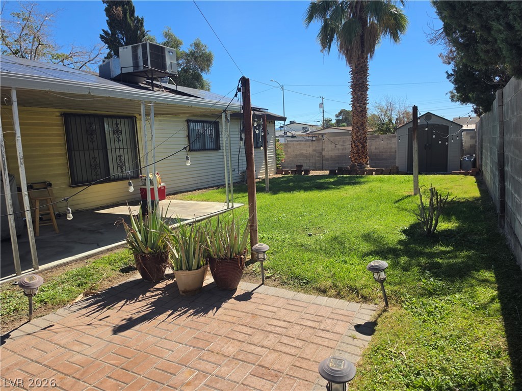 5289 Reeder Circle Las Vegas, NV 89119 - Photo 37 of 40 A spacious green lawn and brick patio offer plenty of room for outdoor relaxation.