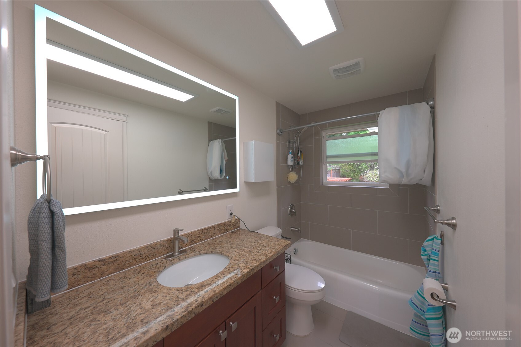 17812 Southeast 146th Street Renton, WA 98059 - Photo 10 of 39 a bathroom with a granite countertop sink toilet and mirror