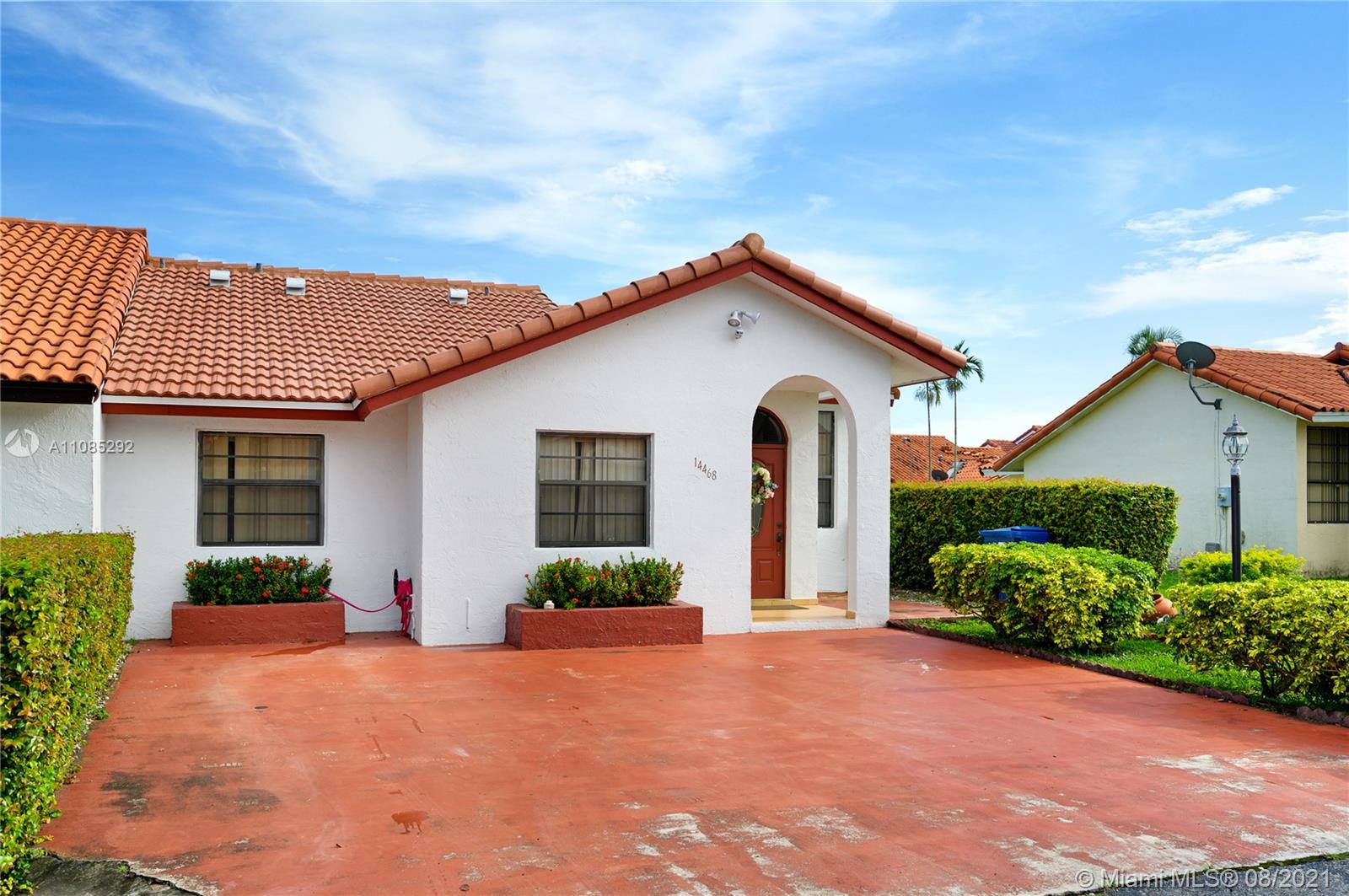 14468 Southwest 50th Terrace Miami, FL 33175 - Photo 15 of 15 a front view of a house with a yard and potted plants