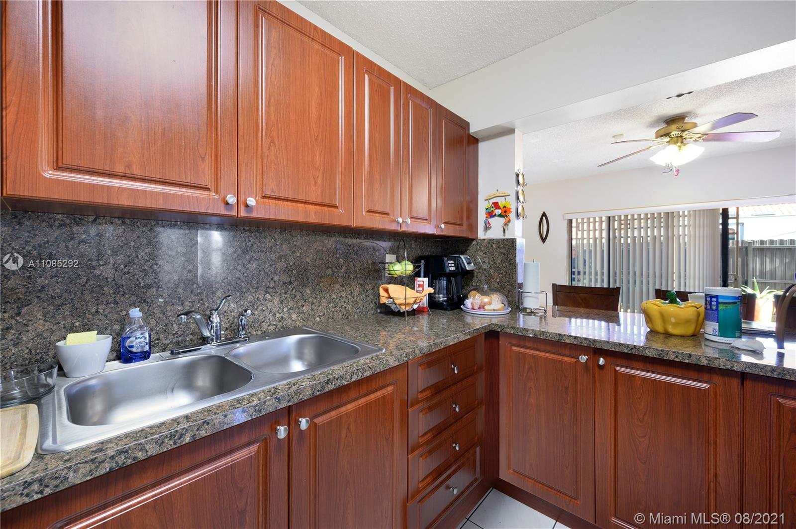 14468 Southwest 50th Terrace Miami, FL 33175 - Photo 4 of 15 a kitchen with stainless steel appliances granite countertop a sink a counter space and cabinets