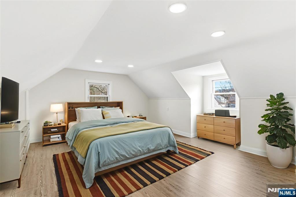 703 Elm Street Roselle, NJ 07203 - Photo 12 of 17 a bedroom with a bed and wooden floor