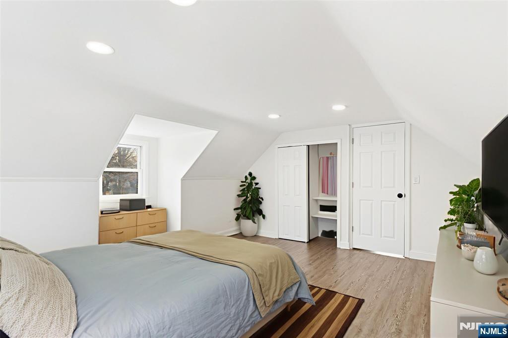 703 Elm Street Roselle, NJ 07203 - Photo 13 of 17 a bedroom with a bed and a potted plant