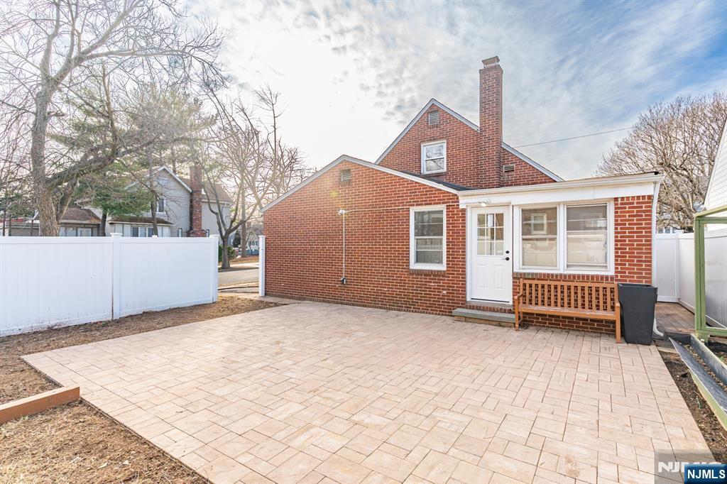 703 Elm Street Roselle, NJ 07203 - Photo 17 of 17 a backyard of a house with barbeque oven and wooden fence