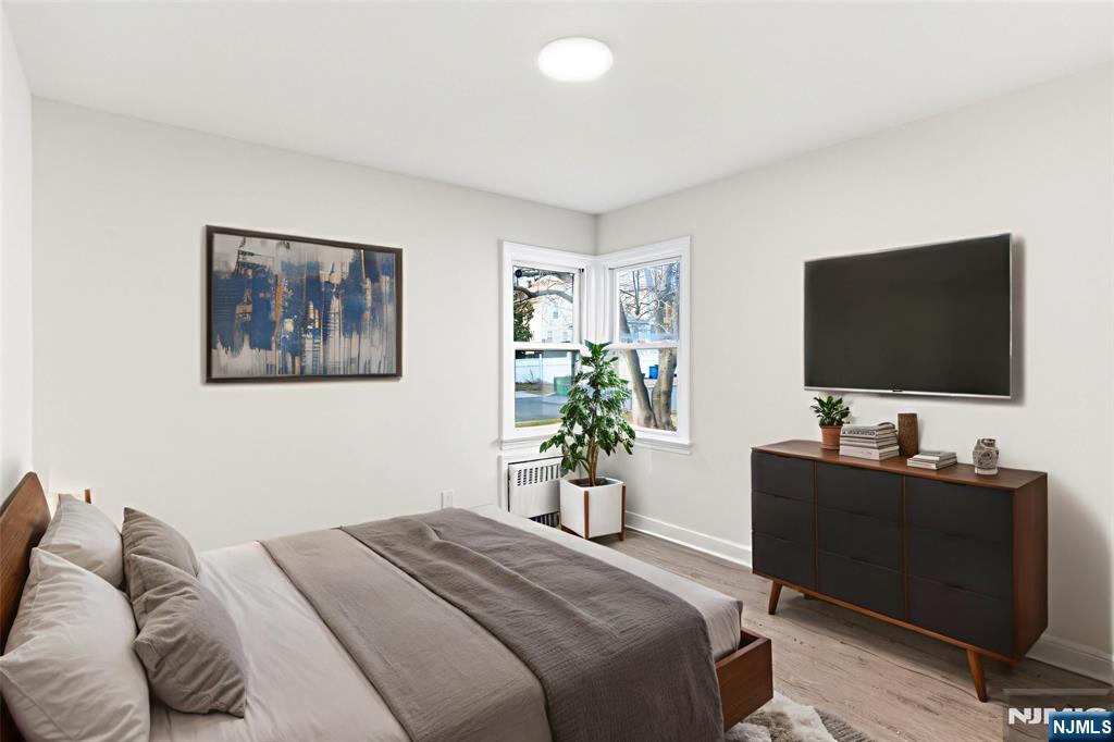 703 Elm Street Roselle, NJ 07203 - Photo 10 of 17 a bedroom with a bed and a flat screen tv