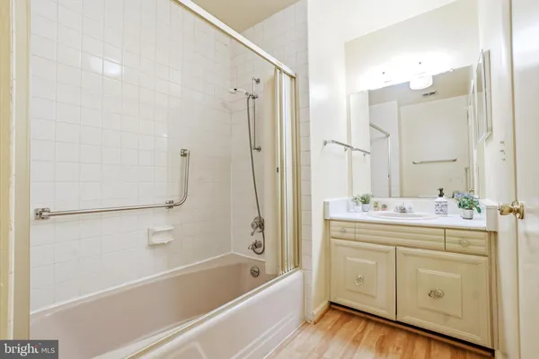 a bathroom with a bathtub a sink a vanity and a shower