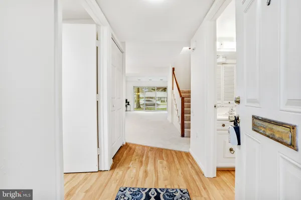 a view of hallway with furniture and wooden floor