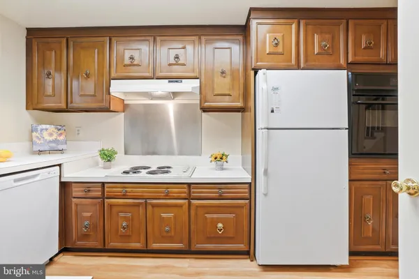 a kitchen with a refrigerator and a stove