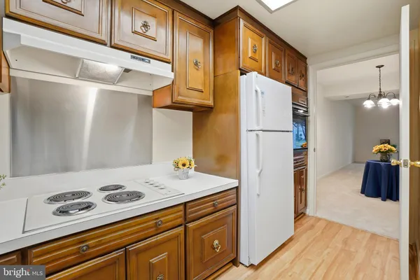 a kitchen with a refrigerator and a stove