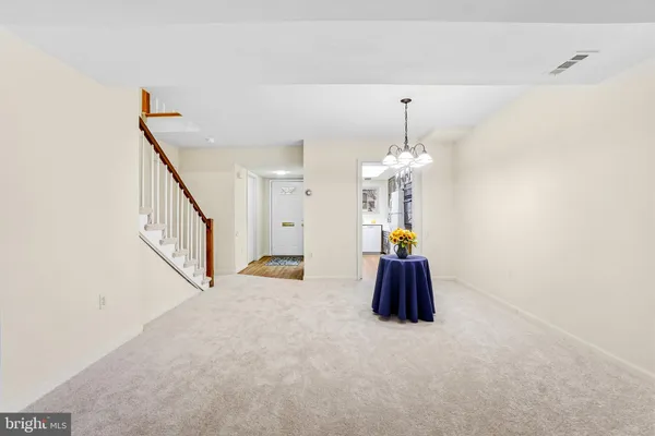a hallway with a chandelier and a chandelier