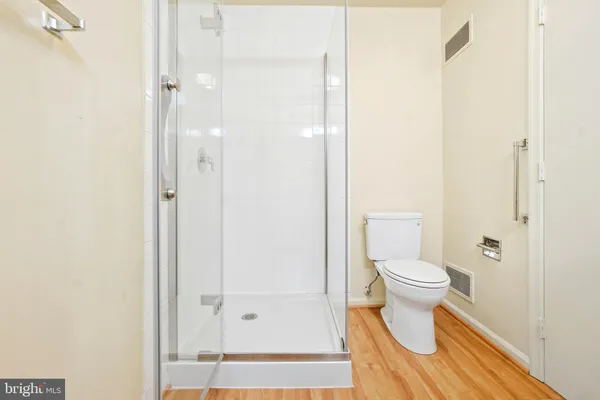 a bathroom with a toilet and a shower