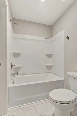 a bathroom with a toilet and a bathtub